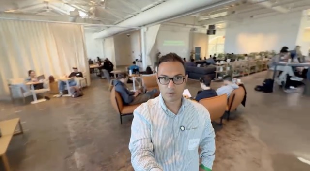 Aemal at SHACK15 with participants working behind him